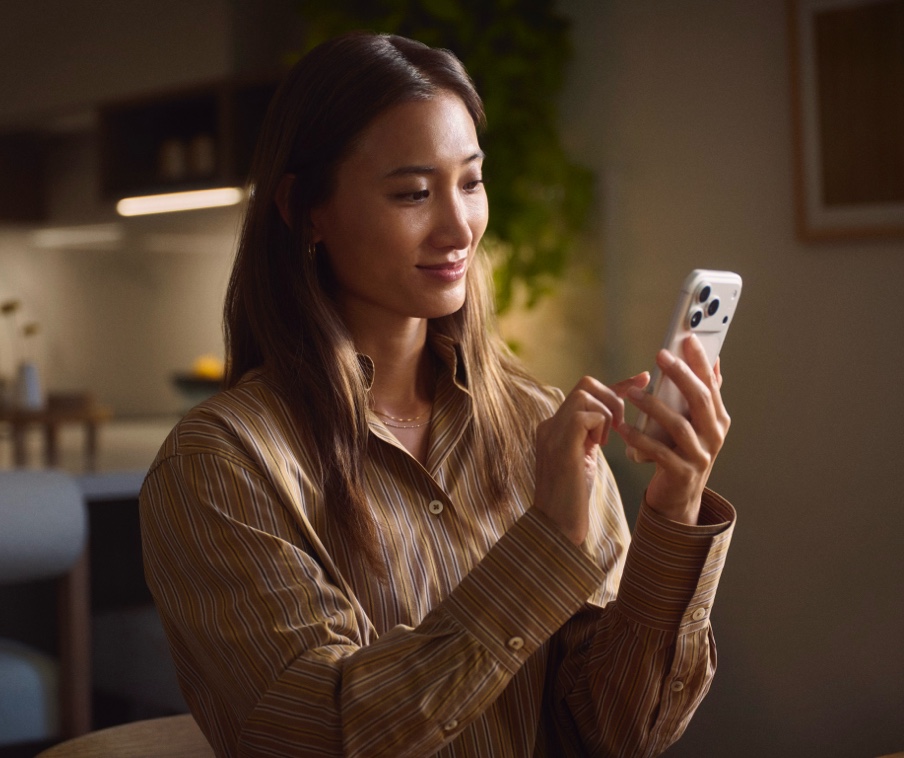 A person looking at an iPhone. 