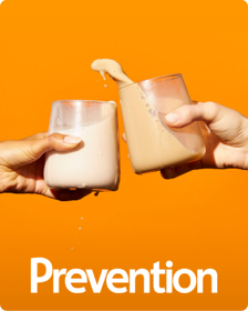 The cover of Prevention with to hands clinking glasses filed with milky liquid.