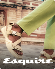 The cover of Esquire featuring an image of feet in sandals walking down a European street.